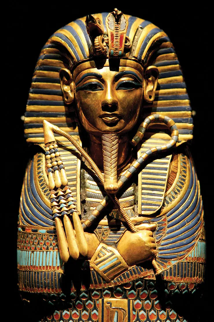 Ancient Egyptian pharaoh mask in a museum display